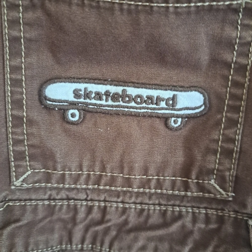 Gymboree Brown Shortalls – “Skateboard” Embroidered Pocket – Size 18-24 Months
